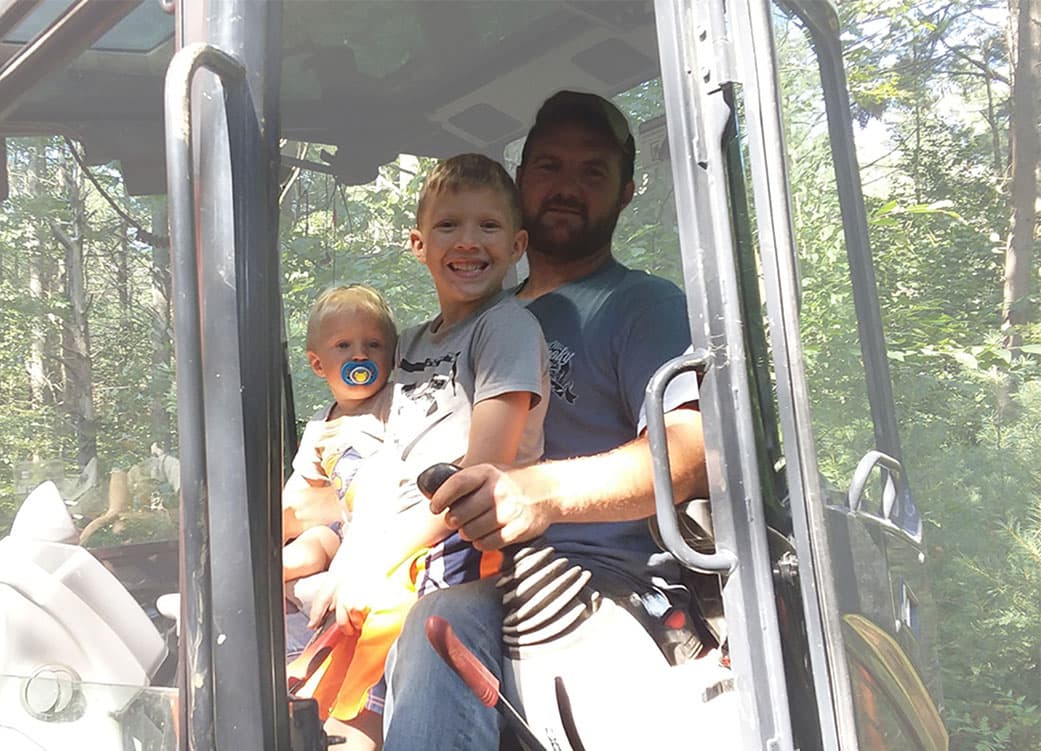 Photo of BW Excavation owner and children in tractor