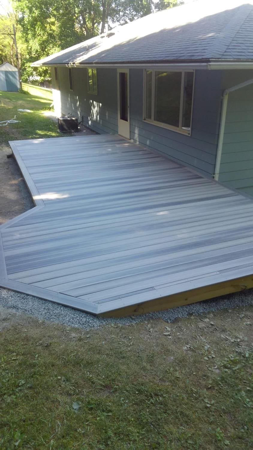 Newly built gray composite deck with gravel base at residential home
