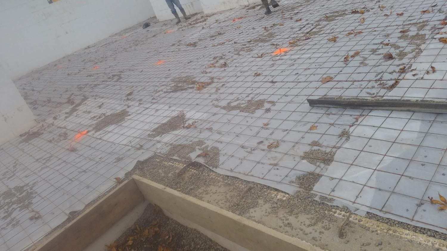Rebar grid laid in concrete foundation forms during construction