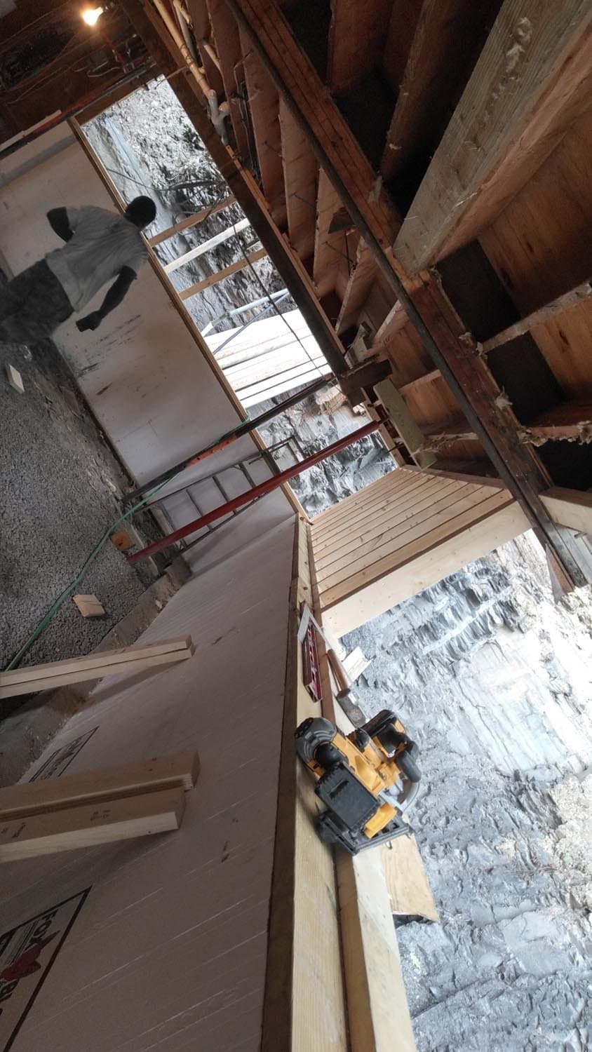 Inside view of foundation construction showing exposed beams and snowy exterior work area