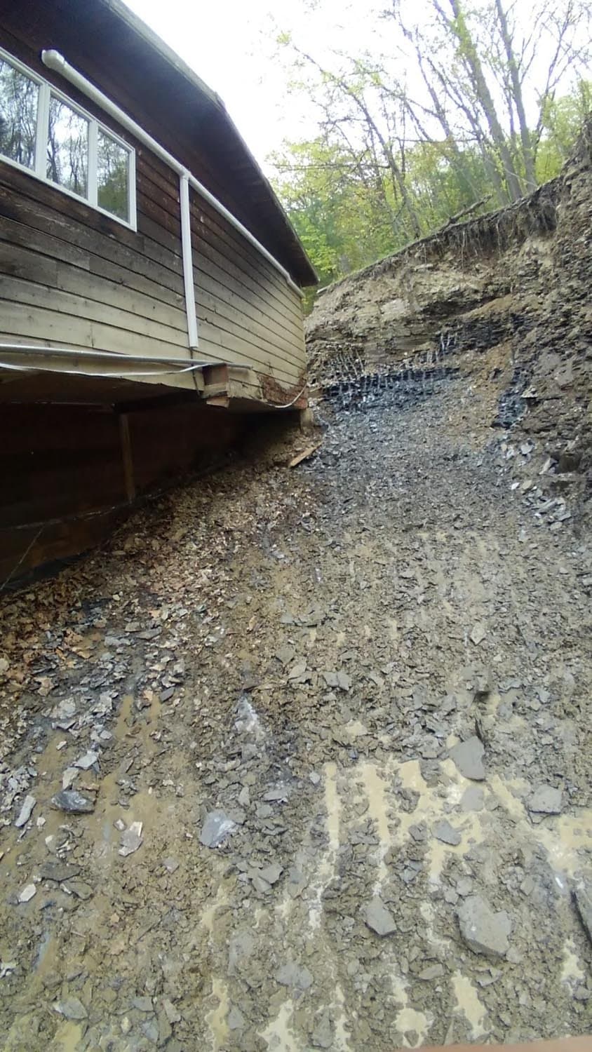 House foundation with exposed soil excavation and erosion control fabric