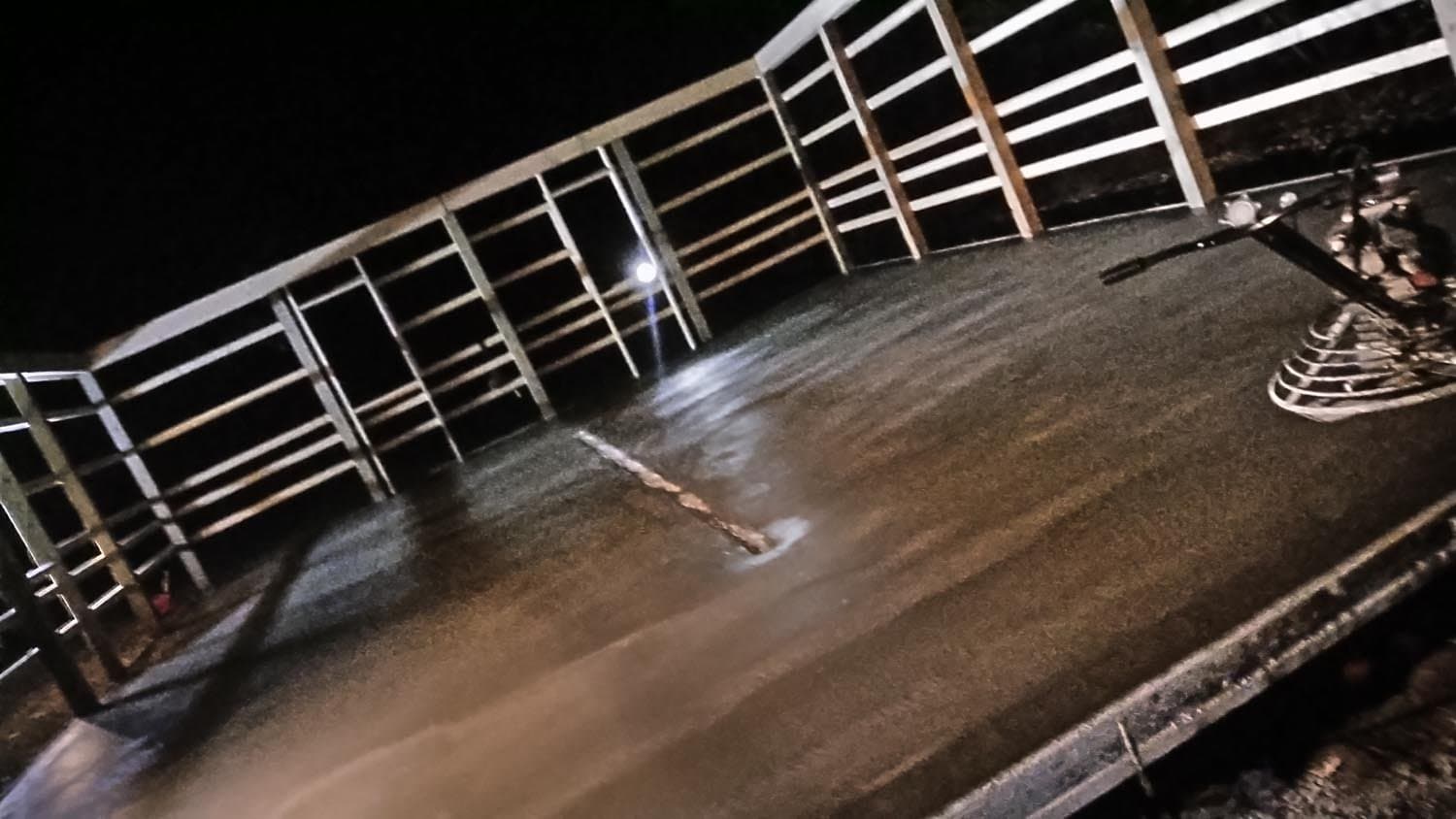 Concrete foundation slab with rebar and wooden wall framing at night