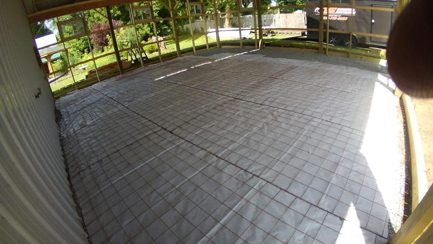 Radiant floor heating mesh installed in pole barn under construction