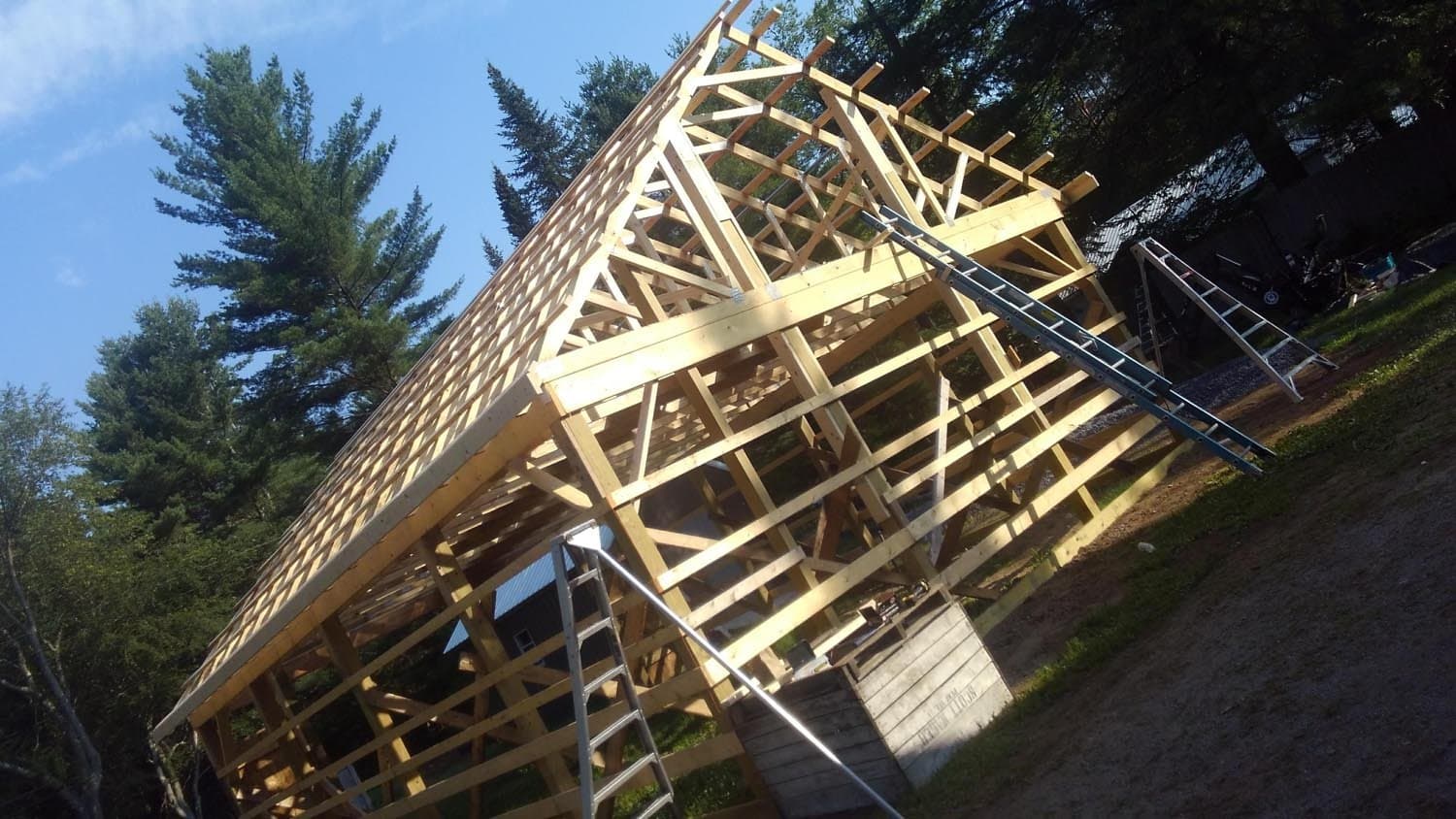 Wooden roof trusses and framing during pole barn construction