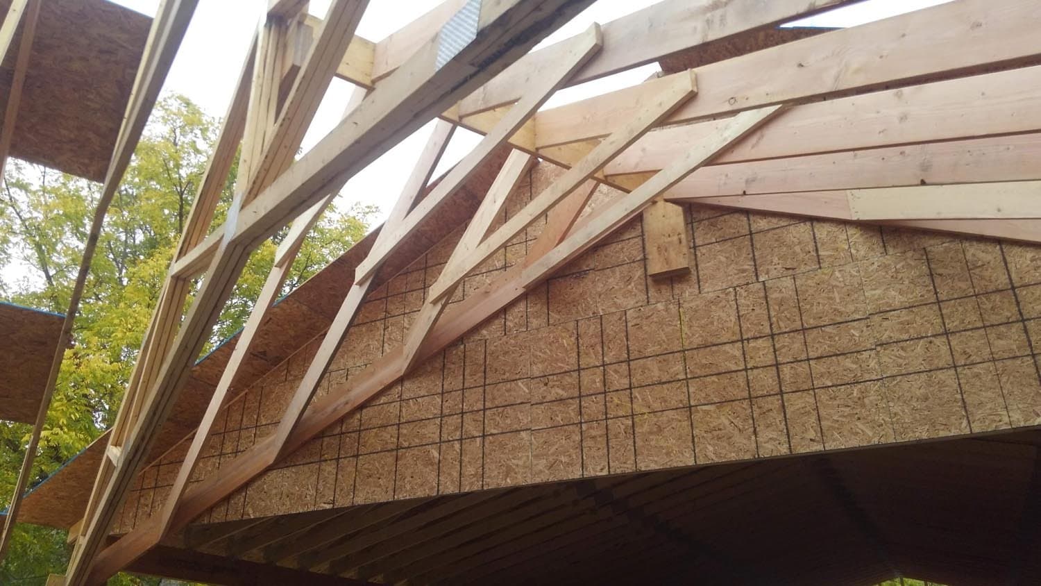 Wooden roof framing and rafters during pole barn construction