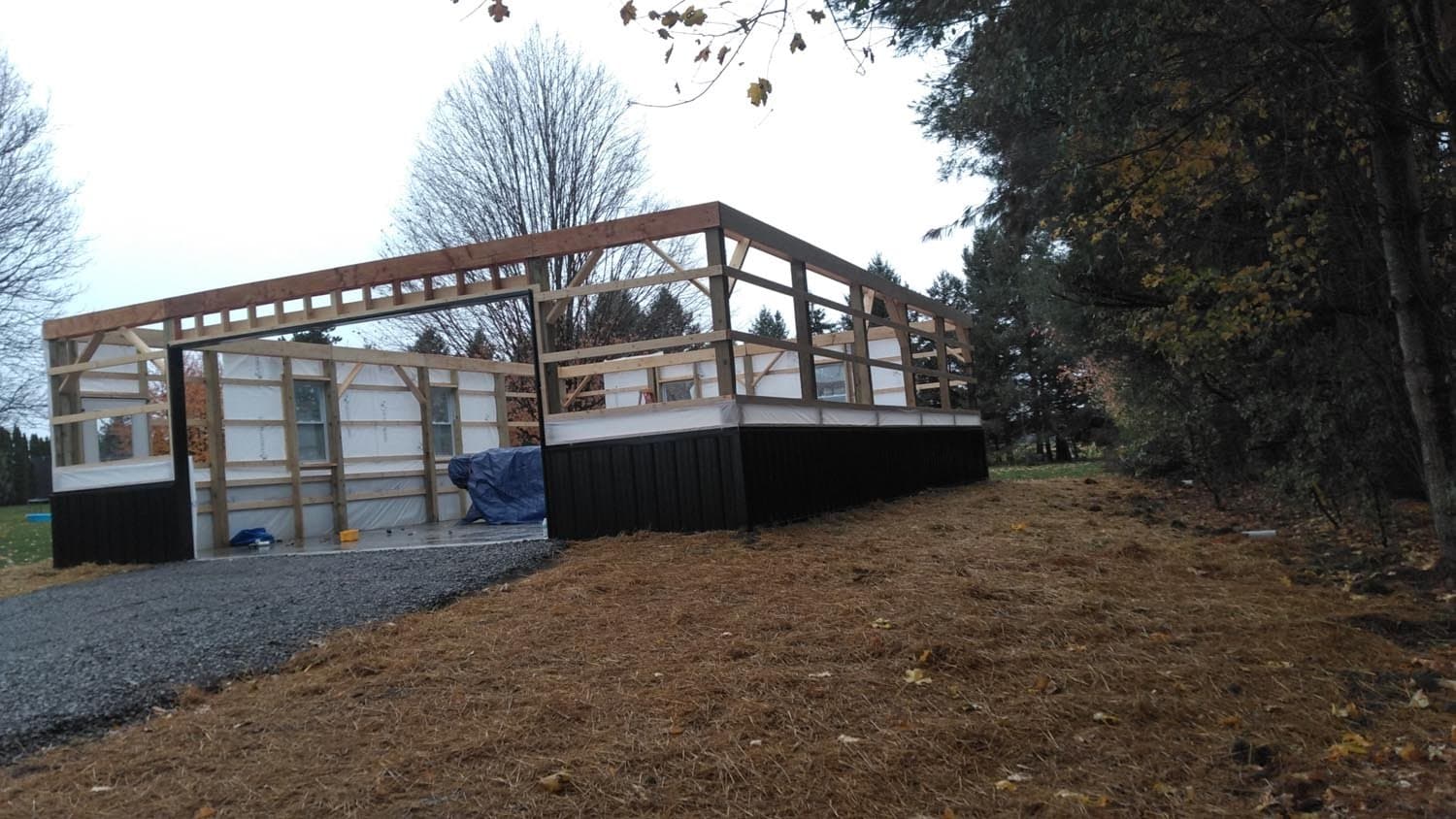Wooden frame structure of pole barn during construction on rural property