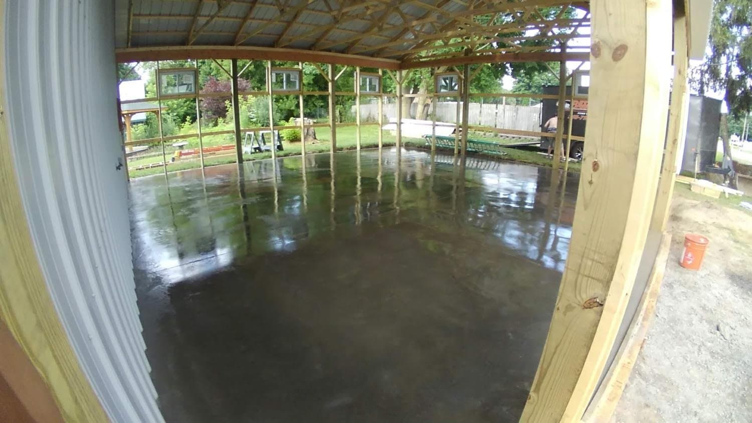 Freshly poured concrete floor in pole barn under construction